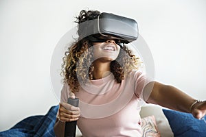 Black woman experiencing virtual reality with VR headset photo