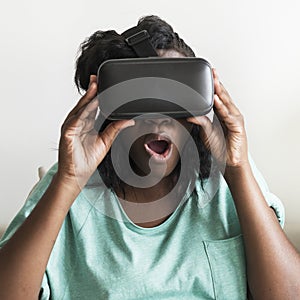 Black woman experiencing virtual reality with a VR headset photo