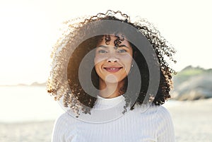 Black woman, face and portrait at beach for vacation, freedom and smile with natural hair and beauty. Happy young model