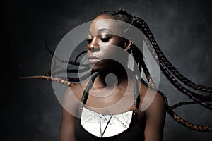 Black woman with the flying braided long hair