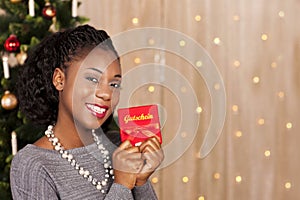 Black woman in front of christmas tree