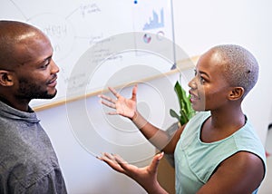 A Black woman gestures in heated discussion with coworker on strategy plan