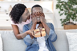 Black woman giving her boyfriend birthday gift