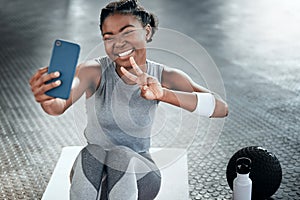 Black woman, gym selfie and peace with smile on floor for fitness, workout and wellness on social media app. Influencer