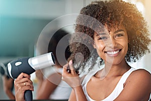 Black woman, hairdryer and hair with texture in portrait, curly hairstyle or frizz for morning routine in bathroom