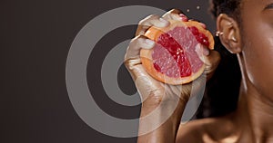 Black woman, hand and grapefruit with health in studio for skincare, detox and beauty with natural product for wellness