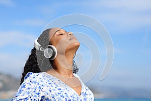 Black woman with headphone breathing listening guide