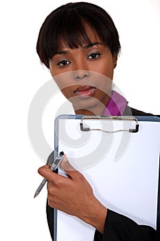 Black woman holding clipboard.