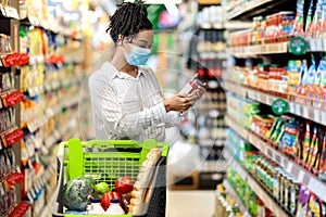 Black Woman Holding Food Product Doing Grocery Shopping In Supermarket