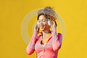 Black woman listening music on headphones
