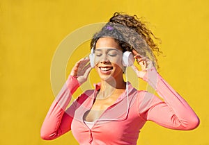 Black woman listening music on headphones