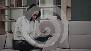 Black Woman Making Online Transaction On Sofa