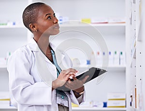 Black woman, pharmacist and tablet for inventory inspection or checking stock at the pharmacy. African female person in