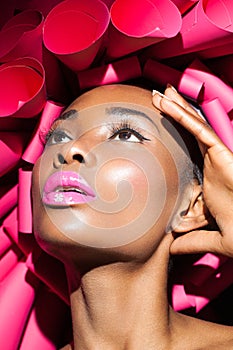 Black woman in pink creative hat.