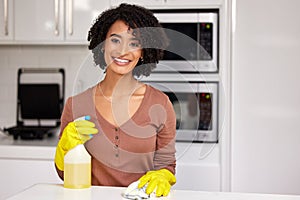 Black woman, portrait and cleaning counter in kitchen, wipe glass and spray chemicals for hygiene. Female person, maid