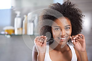 Black woman, portrait and floss for teeth in bathroom, dental health and wellness for fresh breathe at home. String