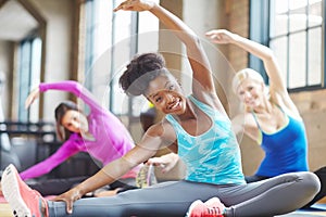 Black woman, portrait and instructor at yoga class, stretch and yogi for exercise on mat. Female person, trainer and