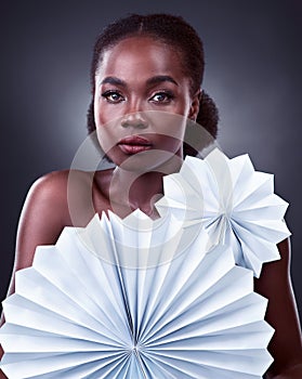 Black woman, portrait and origami fans in studio, cosmetics and oriental beauty on dark background. Female person, skin