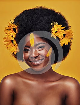 Black woman, portrait and sunflower with skincare in studio for natural glow, cosmetics or soft skin. Person, smile and