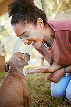 Black woman, puppy and happy with smile, playful and being loving outdoor on grass. Love, African American female and