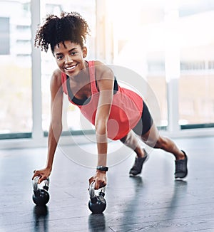Black woman, push up and kettlebell in gym portrait for fitness, strong arms and core in workout. Female person