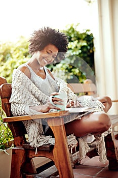 Black woman, reading and backyard patio with book and coffee feeling relax and happy. Happiness, African female person