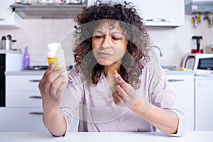 Black woman reading label about medication recipes