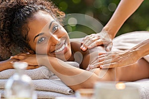 Black woman relaxing during spa massage