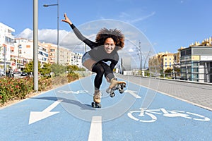 Black woman on roller skates riding on bike line