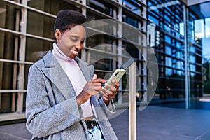 Black woman scrolling news on smartphone