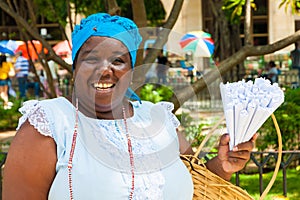 Black woman selling roasted peanuts in Havana