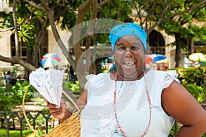 Black woman selling roasted peanuts in Havana