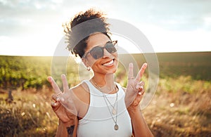Black woman smile, peace hand sign and happy countryside nature at summer sunset. African American girl, portrait of