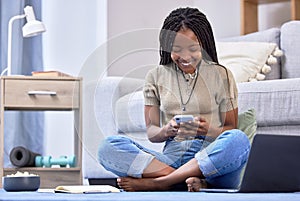 Black woman, student and phone with smile for social media, chatting or texting sitting on floor in living room. Happy