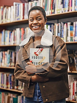 Black woman student, portrait and library with book, research or medical education with smile. African gen z woman