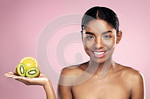 Black woman, studio portrait and fruit for makeup with tropical food, clean beauty and vitamin c. African model girl