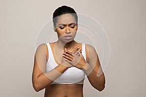 Black woman suffering from acid reflux or heartburn