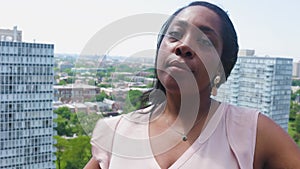 black woman is talking into the camera outdoor
