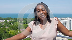 Black woman is talking into the camera outdoor