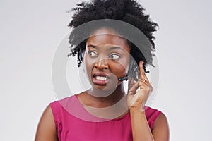 Black woman, talking or listening with headset in studio background for consultant, call centre or crm. Female person