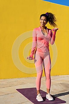 Black woman training fitness outdoors with curly hair