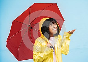 Black woman, umbrella or hand checking for rain on isolated blue background in Brazil city. Person, anxiety or student