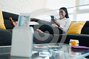 Black Woman Using Portable Wi-Fi Printer For Printing Pictures