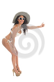 Black woman in white bikini with straw hat