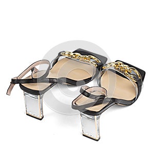 Black women's sandals on a medium transparent wide heel with a beige insole and a blunt toe on a white background
