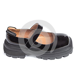 Black women's shiny glossy leather sandals on thick rubber sole on a white background