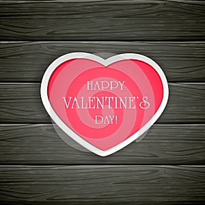 Black wooden background with pink Valentines heart