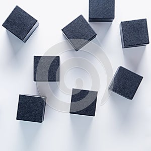 Black wooden cubes on a white background, top view