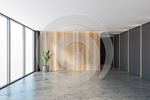 Black and wooden empty reception hall, grey floor near windows