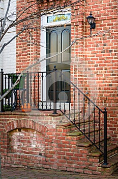 Black Wooden Front Door of a Traditional Brick House